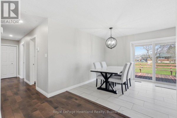 Modern dining room with table, chairs, deck access - 25 Vincent Street South Bruce