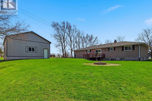 Brick house with deck and shed, fire pit in yard - 25 Vincent Street South Bruce