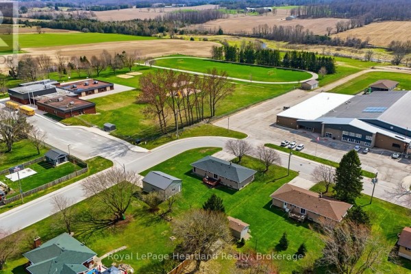 Aerial view of school, community center, sports field, and houses - 25 Vincent Street South Bruce