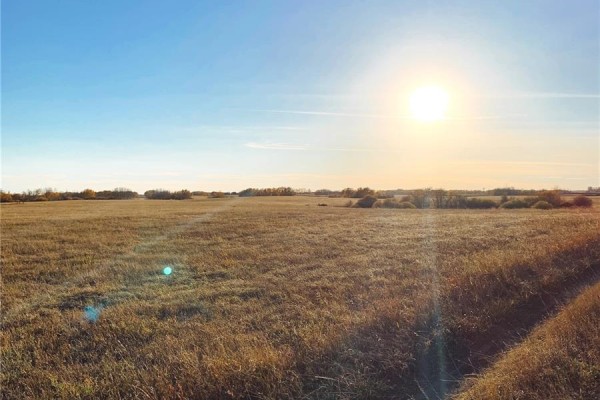 Expansive view of a dry grass field under a bright sun and blue sky. - 25 Wakonda Drive, Hoodoo Rm No  401