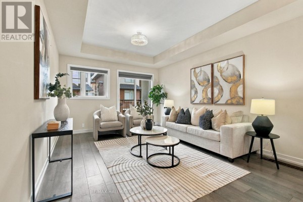 Living room with a beige sofa, two armchairs, coffee tables, and large windows with blinds. - 250 Finch Avenue, Pickering