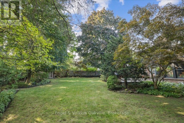 Aerial view highlighting the manicured lawn and driveway of the home in a wooded area. - 250 Gatestone Avenue, Oakville