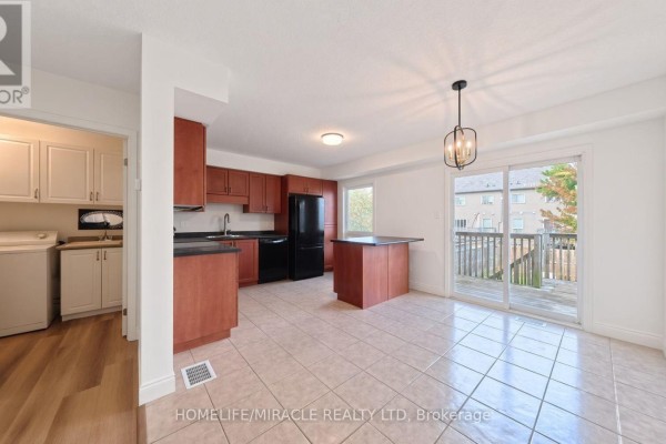 Kitchen and dining area with tile floor, wood cabinets, black appliances, and patio door. - 250 Parkvale Drive, Kitchener