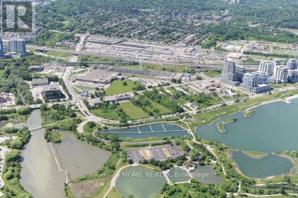 Aerial view of a Toronto neighborhood with condo buildings, parkland, and a lake. - 2501 - 10 Park Lawn Road, Toronto