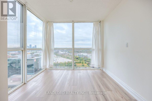 View of city buildings and greenery from a high-rise window. - 2504 - 5 Concorde Place, Toronto