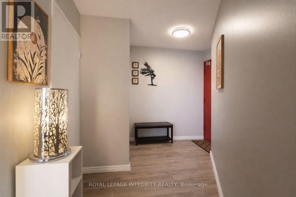 Open-concept living area with dining space, sofa, and modern decor. - 2505 - 900 Dynes Road N, Ottawa