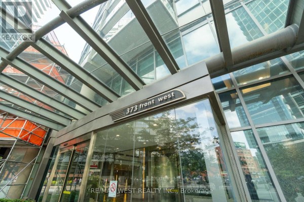 Close-up of the 373 Front West building sign above glass doors. - 2509 - 373 Front Street W, Toronto