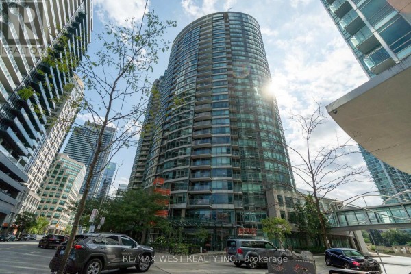 Tall cylindrical apartment building with glass balconies and surrounding urban towers. - 2509 - 373 Front Street W, Toronto