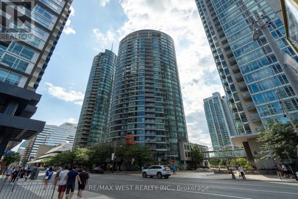 View of glass apartment towers on a sunny day with street traffic. - 2509 - 373 Front Street W, Toronto