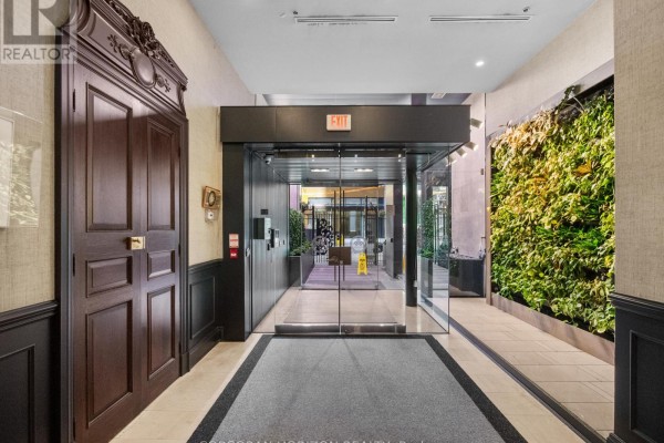 Open-concept kitchen and living space with a large island and modern cabinetry. - 2509 - 375 King Street W, Toronto