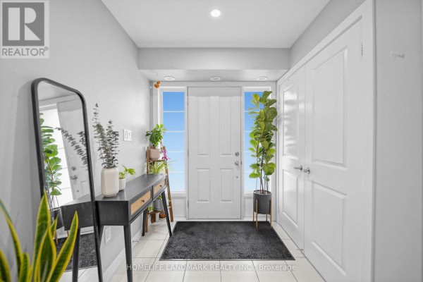 Interior foyer with white walls, tiled floor, and white doors. - 251 - 60 Parrotta Drive, Toronto