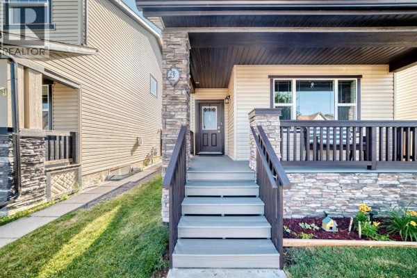 Front porch steps leading to the entrance of the Calgary home, featuring stone and wood detailing. - 251 Skyview Point Road Ne, Calgary