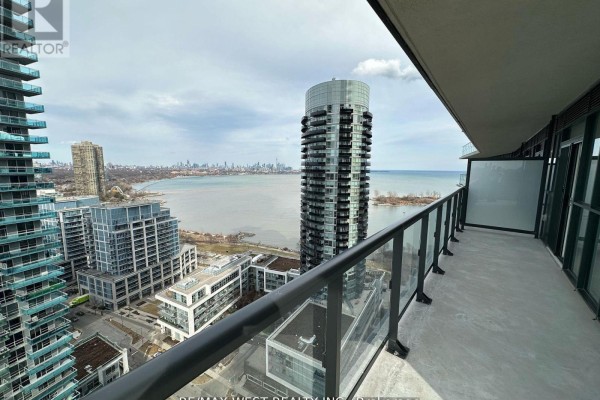 Balcony with glass railings offering panoramic views of Lake Ontario and Toronto skyline. - 2511 - 38 Annie Craig Drive, Toronto