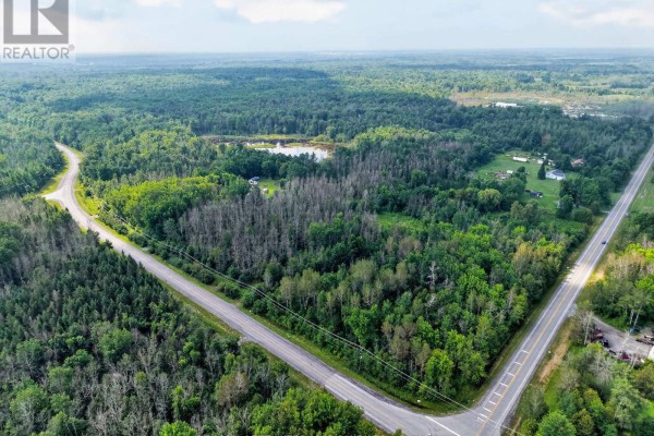 Aerial view of a rural intersection with roads cutting through a heavily wooded area. - 2512 County Road 30 Road, North Glengarry