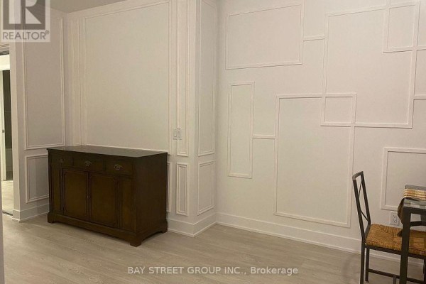 Dining room with dark wood buffet and white paneled walls. - 2515 - 2545 Simcoe Street N, Oshawa