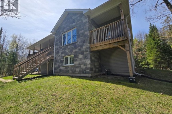 Aerial view of the property showing wooded landscape and nearby homes - 2516 Irish Line, Coldwater