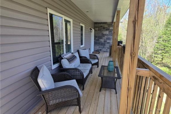 Stairs leading to the entrance of the house with wooden railing - 2516 Irish Line, Coldwater