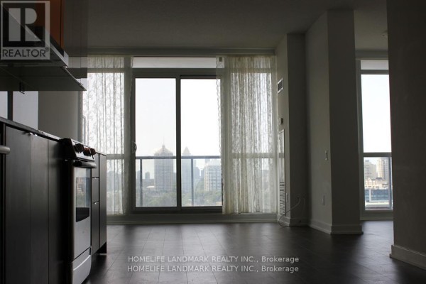 Living area with floor-to-ceiling windows offering a panoramic view of the city skyline. - 2517 - 121 Mcmahon Drive, Toronto
