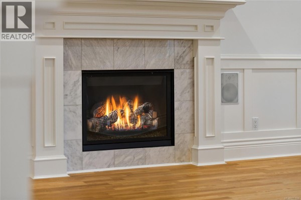 Close-up of a gas fireplace with marble surround and intricate white mantelpiece detailing. - 2517 Asquith St, Victoria