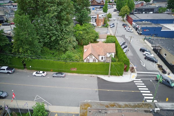 Aerial view of the property and adjacent street with cars and businesses. - 2517 Montvue Avenue, Abbotsford