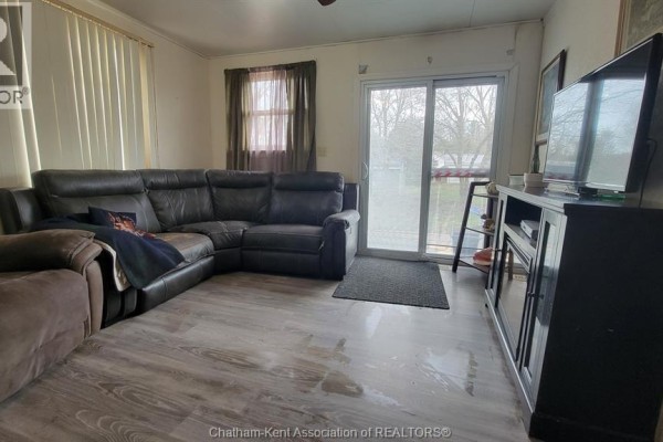 Living room with sectional sofa, TV, and sliding door - 252 Queen Street Highgate