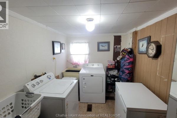 Laundry room with washer, dryer, basin, basket, and freezer - 252 Queen Street Highgate