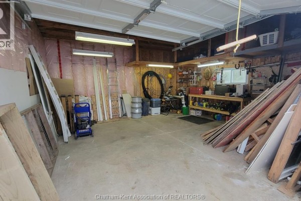 Garage with workbench, lumber storage, and double door - 252 Queen Street Highgate