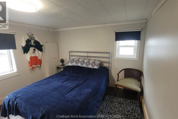 Bedroom with bed, chair, and window - 252 Queen Street Highgate