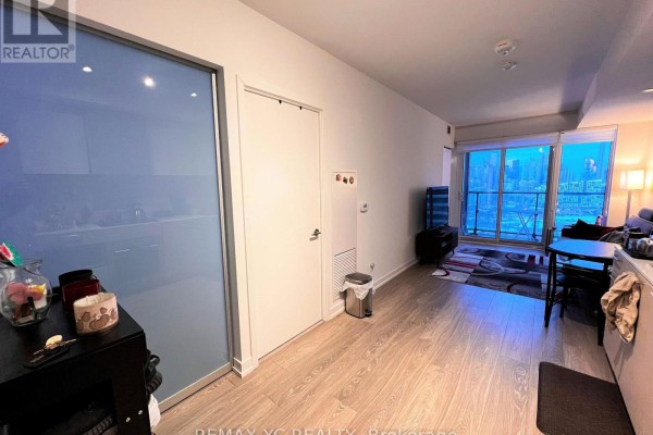 View of hallway, closet, and living area with city view balcony. - 2520 - 19 Western Battery Road, Toronto