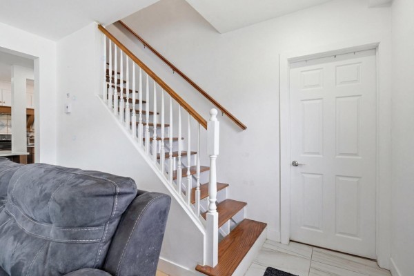 Interior view of a white staircase with wooden handrails and a white door to the right. - 2523 Rue St-louis, Gatineau
