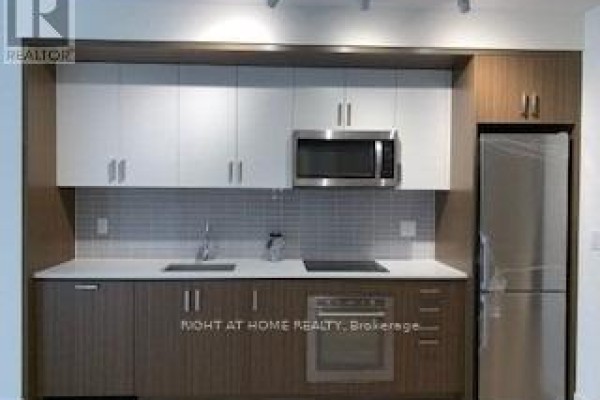 Modern kitchen with two-tone cabinetry, stainless steel appliances, and a tile backsplash. - 253 - 1575 Lakeshore Road W, Mississauga
