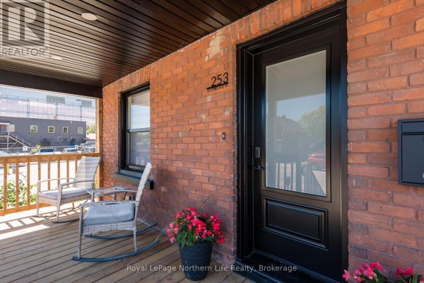Detail view of the front door, window, and brickwork on the porch of 253 Second Avenue W. - 253 Second Avenue W, North Bay