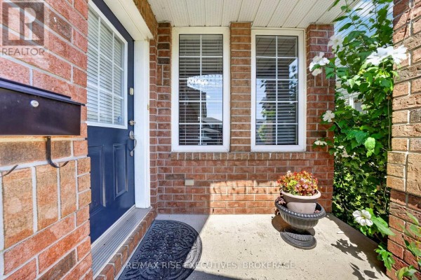 Front door with a mailbox, flanked by brick and windows. - 254 Ellesmeer Avenue, Kingston