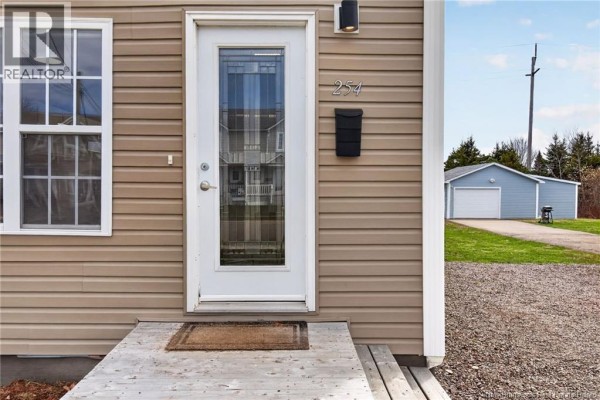 Aerial view of the property showing the house, backyard, and neighboring homes. - 254 Highlandview Road, Moncton
