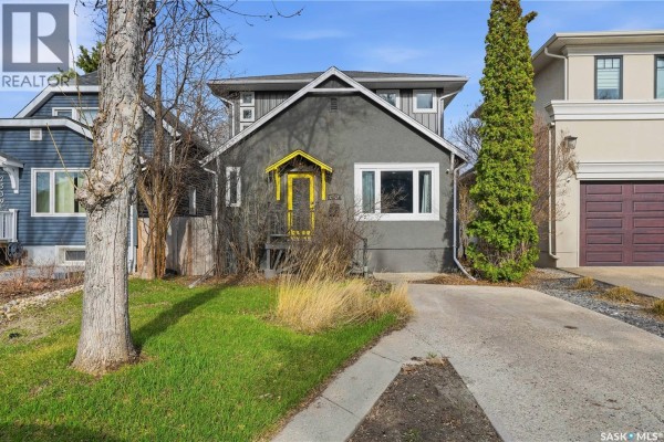 Front exterior of 2543 Garnet Street, a grey house with a driveway and garage. - 2543 Garnet Street, Regina