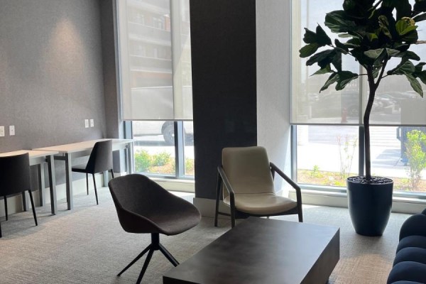 Common area with seating, desks, chairs, large windows, and a potted plant. - 925 - 2545 Simcoe Street N, Oshawa