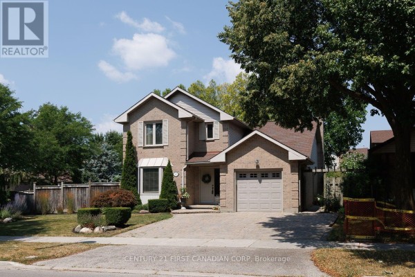 Front view of a brick house with a bay window and manicured shrubs. - 255 Deveron Crescent, London South