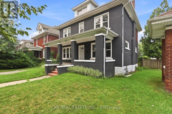 Close-up view of the front porch of the dark grey house with white columns and steps. - 255 Hall Avenue, Windsor
