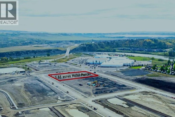 Aerial view of a large undeveloped parcel outlined in red, labeled 1.95 acres Hotel Parcel. - 255 Rockland Avenue, Cochrane