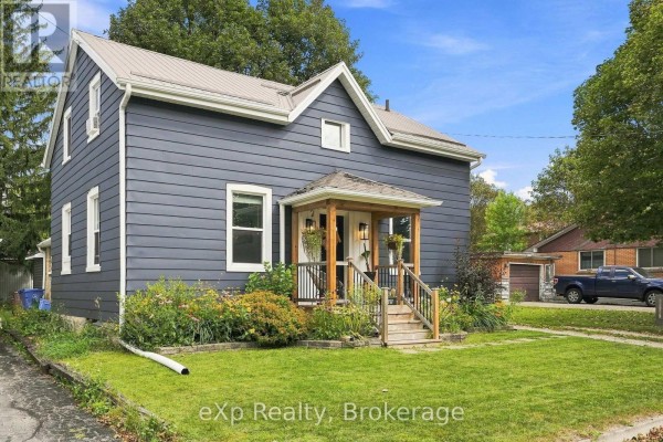 Wooden porch stairs and railing with potted plants and seating visible. - 255 Waterloo Street, Wellington North