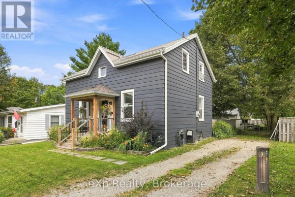 Dark blue house exterior with a covered porch and white trim around windows. - 255 Waterloo Street, Wellington North