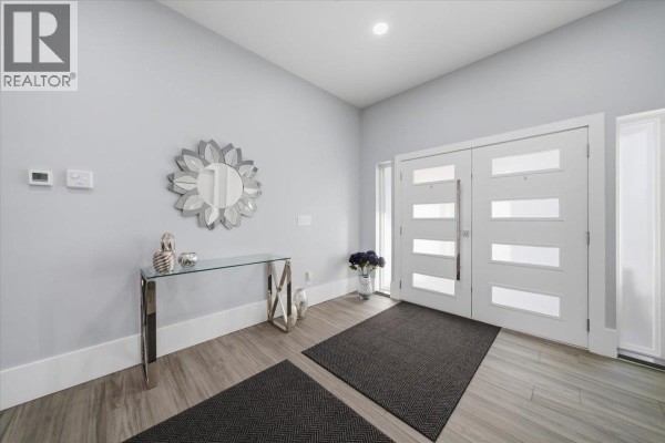 Luxurious bathroom with a large glass shower, freestanding bathtub, toilet, and grey marble tile flooring. - 25507 Bosonworth Avenue, Maple Ridge