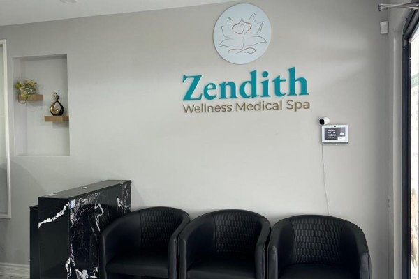 Interior reception area of Zendith with seating and branding on the wall. - 2551 Hurontario Street, Mississauga