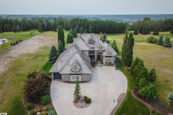 Drone shot of the property showcasing the house, driveway, and surrounding landscape. - #11 25515 Twp Road 511a, Rural Parkland County