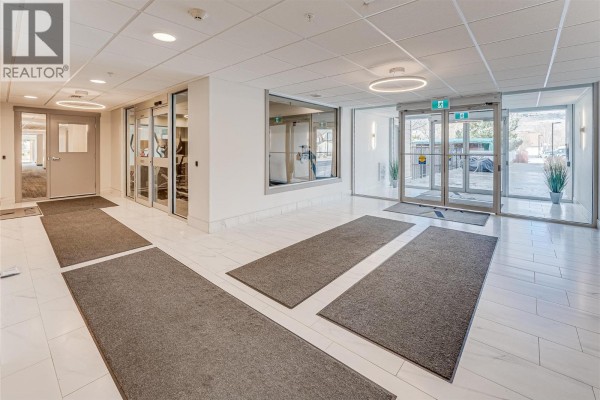 Bright lobby area with tile flooring, seating, and large windows - 2555 Lakeshore Road Unit# 321, Vernon