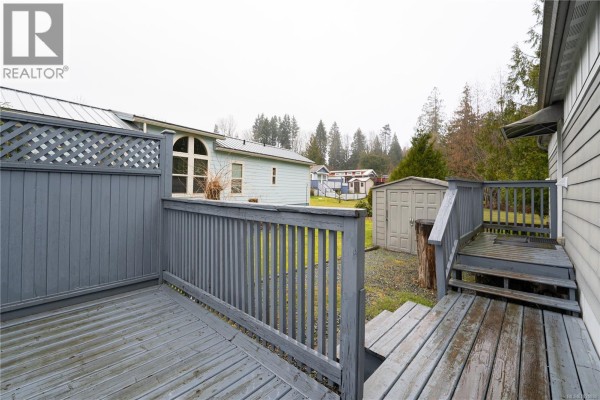 Side view of deck with lattice and access to yard - 256 3042 River Rd, Chemainus