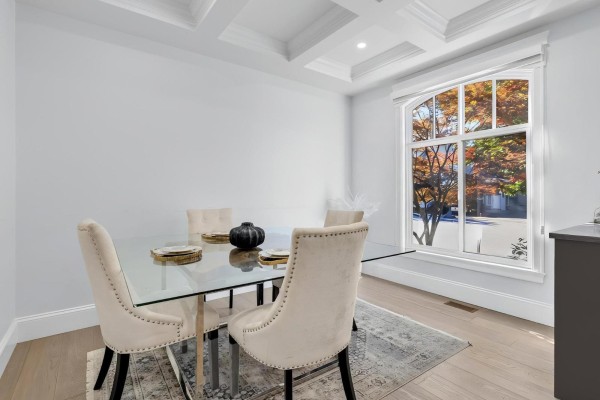 Dining room with a glass-top table, upholstered chairs, and a large arched window overlooking trees. - 2560 163 Street, Surrey