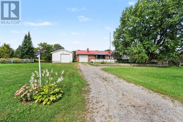 Covered front porch with seating, brick exterior, and view of the property. - 2564 2nd Conc Road, Augusta