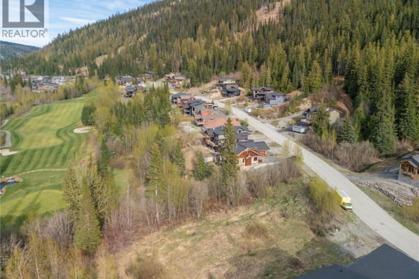 Elevated view of a hillside neighborhood in Sun Peaks with scattered homes and snow-covered slopes. - 2568 Mountain View Drive Lot# 12, Sun Peaks
