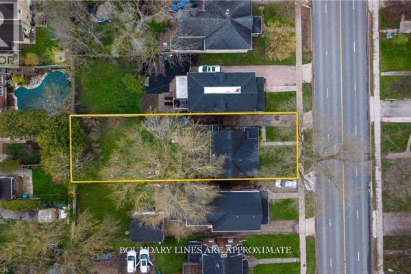 Aerial view of a residential property with a yellow boundary line, showing the house and backyard. - 257 Ontario Street, Stratford